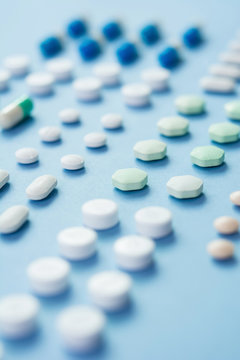 Medical tablets on light blue background