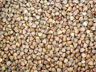 Raw brown buckwheat grain. Texture. Background