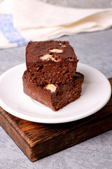 Obraz na płótnie Canvas Homemade chocolate brownie on a white plate
