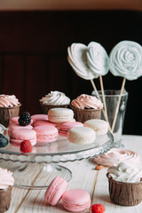 tender berry biscuit cakes in composition, fabric and wooden background