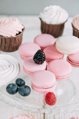 tender berry biscuit cakes in composition, fabric and wooden background