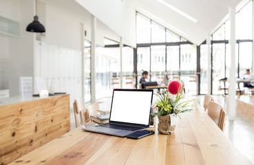 Mock up laptop on wooden table in library