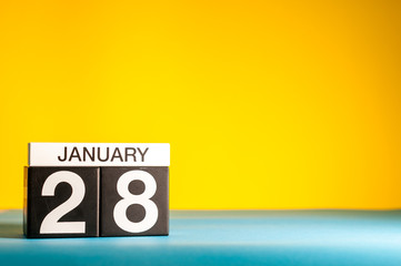 January 28th. Day 28 of january month, calendar on yellow background. Winter time. Empty space for text