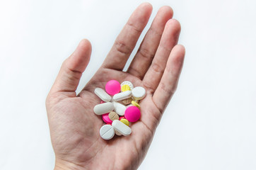 Top view of the pills on the hand and white background, A hand hold the pills and drug, Pile of the drug and pills on the hand.
