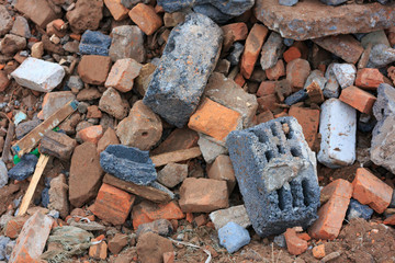 A pile of construction debris is broken brick and concrete.