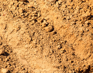Red clay soil on nature as a background