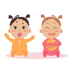 Newborn baby girl twins in long sleeved footies and scratch mittens. Sitting with nipple and ball. Cute little children in pink and orange isoalted on white background