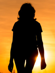 Silhouette of a girl in the sunset