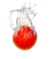 Red tomato under water on a white background