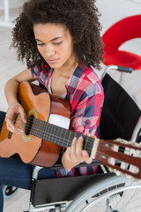 handicapped woman playing guitar