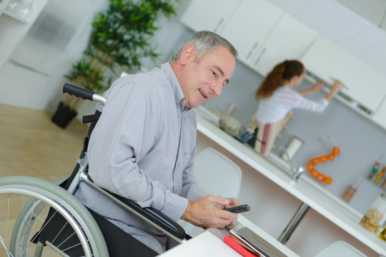 creative businessman in wheelchair on the phone at home