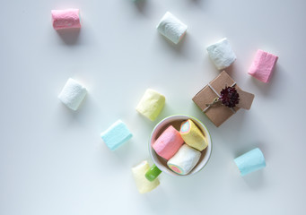 Cup of coffee with marshmallows and gift box