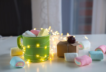 coffee cup with marshmallows and gift box