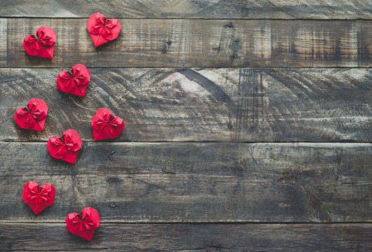 Red paper valentine hearts on wooden background. Space to copy. Top view.