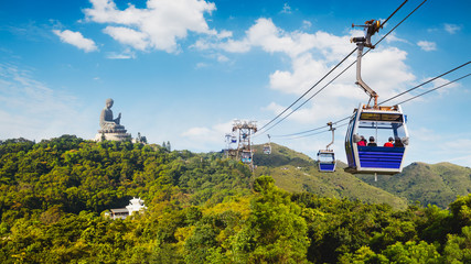 Ngong Ping cable car with big buddha statue in background, Hong Kong China - obrazy, fototapety, plakaty
