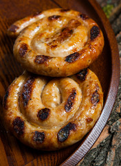 Grilled sausages with sauce ketchup on a wooden table.
