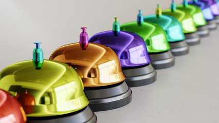 Line of Vibrantly Colored Reception Bells on Simple Light Grey Surface