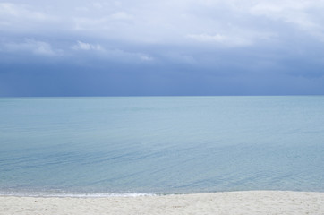 Fototapeta na wymiar Turquoise sea water surface with horizon and blue sky