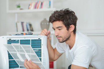 Man assembling air conditioning unit