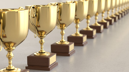 Linear Array of Gold Trophys on a Light Gray Surface