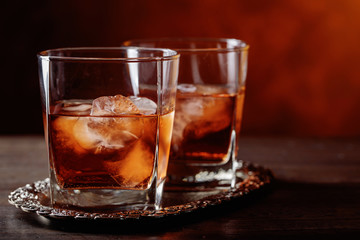 Glass of scotch whiskey and natural ice .