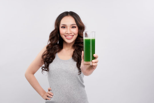 Healthy asian woman holding juice glass. Detox smoothie drink.