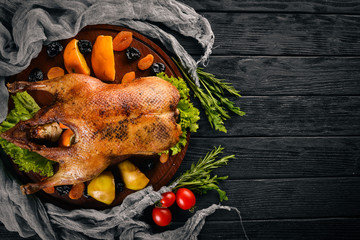 Baked turkey with vegetables and spices. Thanksgiving day. Goose chicken grill. On a wooden background. Top view.
