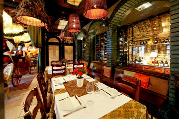 Retro styled restaurant interior, setting table for dinner