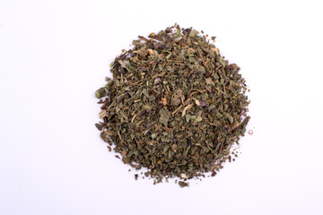 Pile of dry basil. Top view of a portion herbs seasoning isolated on a white background.