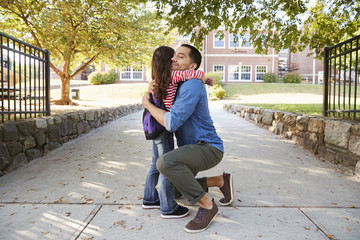 Father Dropping Off Daughter In Front Of School Gates