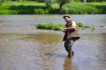 Fisherman fights with fish. The fish has taken the bait and stretched string