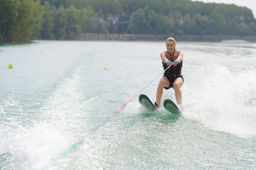 young woman water skiing on a lake