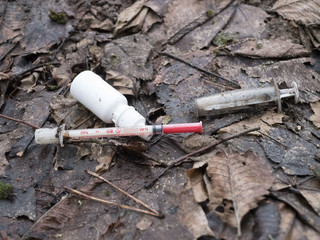 two needles for the syringes and a tube with a cure thrown to earth addicts