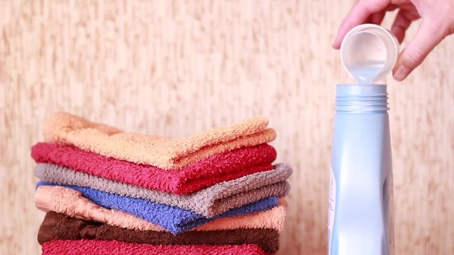 Pouring liquid detergent back into the bottle