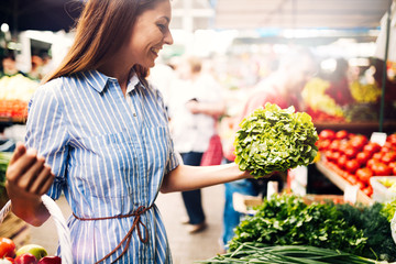 Picture of woman at marketplace buying vegetables