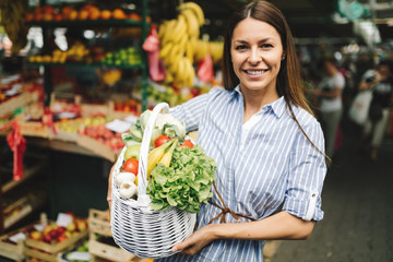 Portrait of beautiful woman holding shopping basket