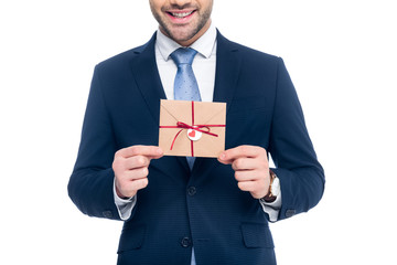 cropped view of beardman holding envelope for valentines day, isolated on white