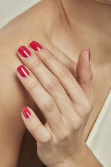 HAND WITH RED NAIL POLISH