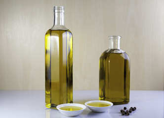 Two bottle olive oil with  peppercorns