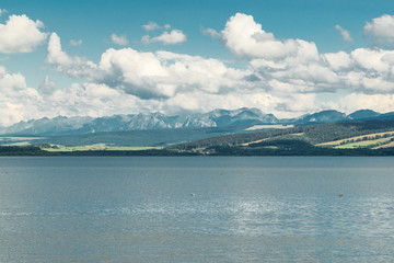 Orava reservoir with mountains in the background