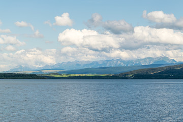 Orava reservoir with mountains in the background