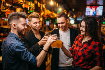 Happy football fans raised their glasses with beer