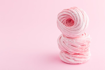 Homemade pink zephyr or marshmallow on pink background