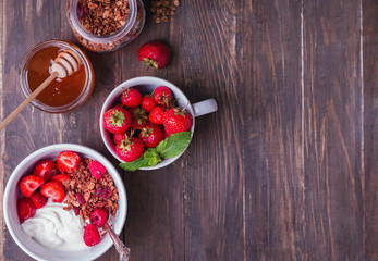 Breakfast yogurt with granola and strawberries