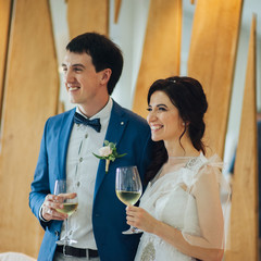 Emotional beautiful newlywed couple smiling at wedding reception