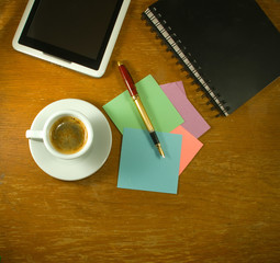  cup of coffee, stationery, keyboard and tablet on the table closeup