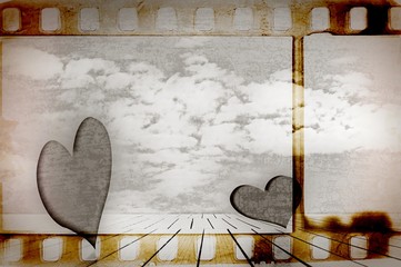 Sepia film strip frame with two hearts in surreal landscape. Valentine's day.