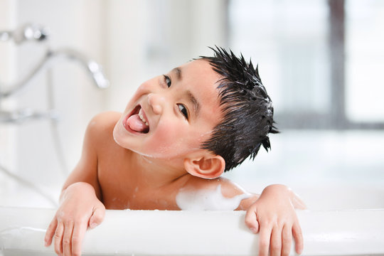 Portrait of playful boy in bubble bath
