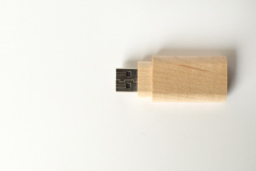 A wooden flash drive against white background