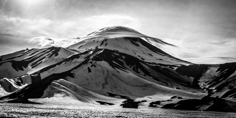 Lenticular (lens-shaped) clouds are over Avachinsky  Volcano. Kamchatka Peninsula, Russia.